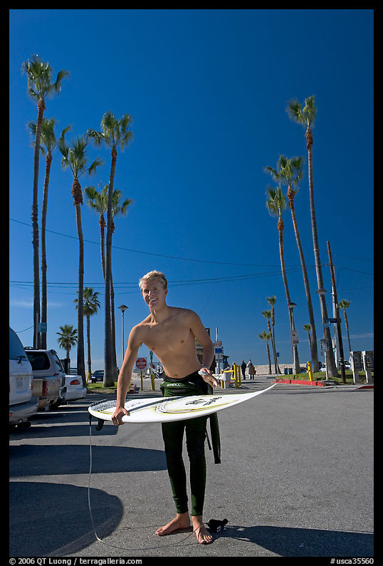 Surfer and palm trees. Venice, Los Angeles, California, USA