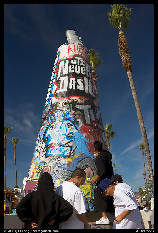 Young men decorating a cone on the beach. Venice, Los Angeles, California, USA
