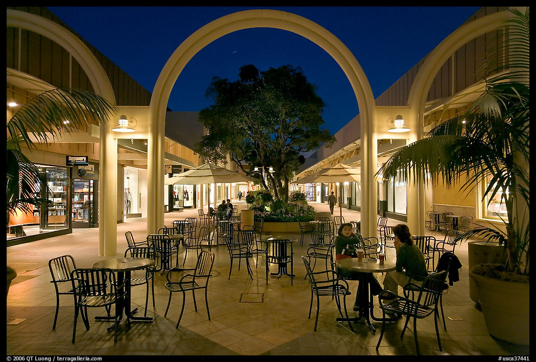 Sitting at outdoor table at night, Stanford Shopping Center. Stanford University, SF Bay area, California, USA
