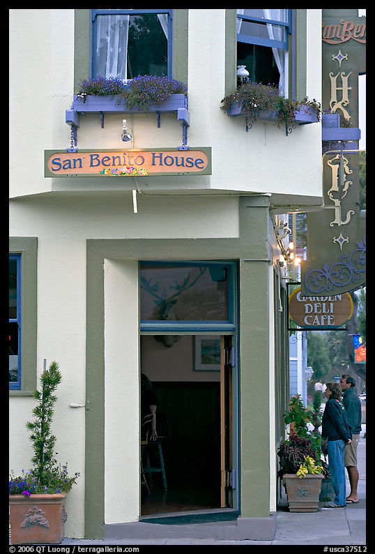 Entrance of historic San Benito House, with couple looking. Half Moon Bay, California, USA