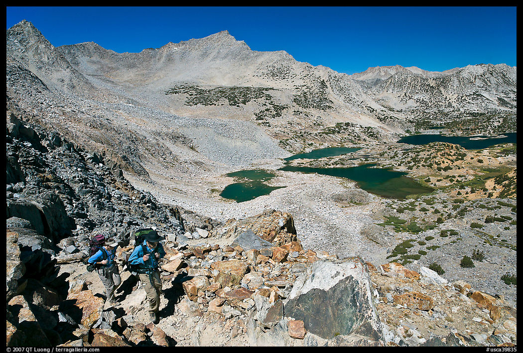 Backpackers hiking up from Saddlebag Lakes, John Muir Wilderness. California, USA