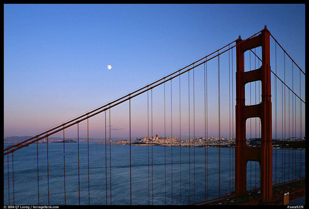 The city seen through the cables of the Golden Gate bridge, sunset. San Francisco, California, USA