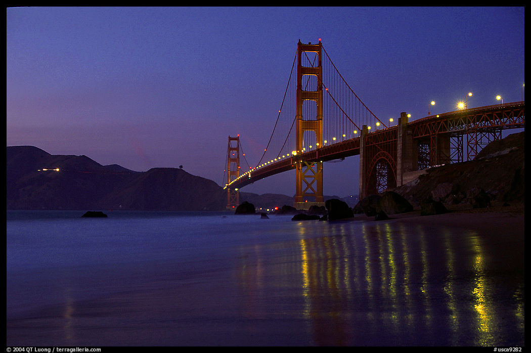Golden Gate bridge and surf with light reflections, seen from E Baker Beach, dusk. San Francisco, California, USA