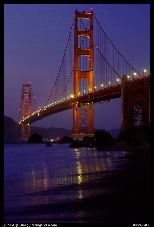 Golden Gate bridge and surf seen from E Baker Beach, dusk. San Francisco, California, USA
