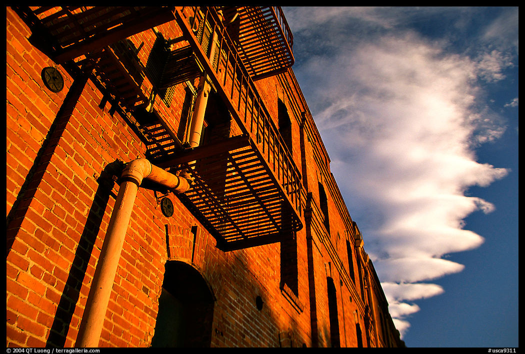 Old brick building and serrated cloud, sunset, Fisherman's Wharf. San Francisco, California, USA