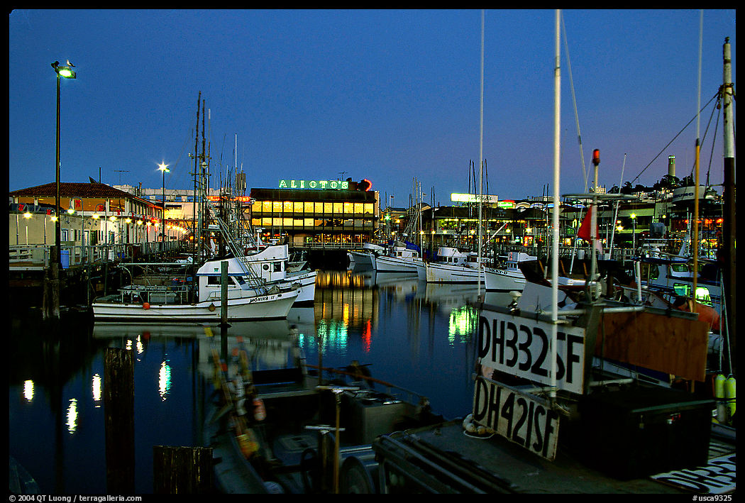 Fishing boat in  Fisherman's Wharf, with Alioto's in the background, dusk. San Francisco, California, USA