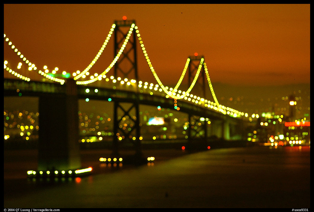 Bay Bridge seen from Treasure Island with defocused lights, sunset. San Francisco, California, USA