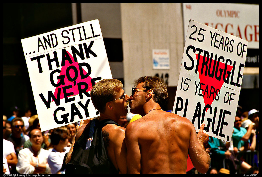 Gay couple with signs during the Gay Parade. San Francisco, California, USA