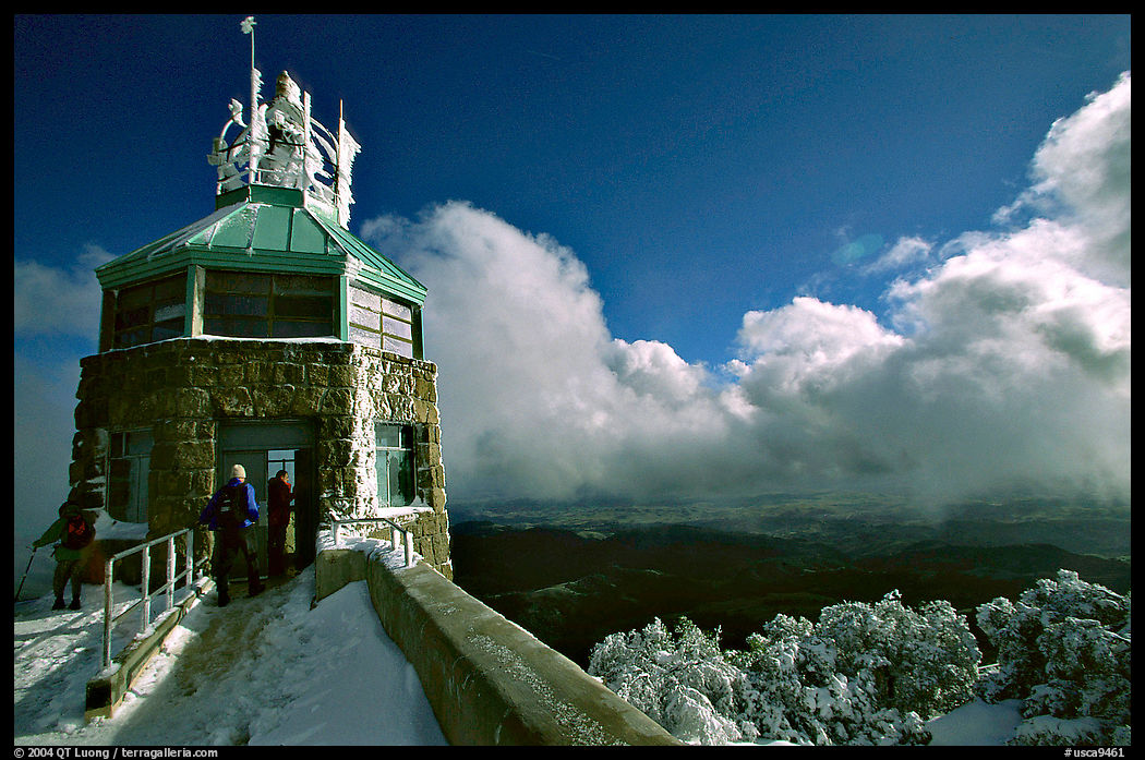 Hikers take refuge in the ice-clad summit tower during a cold winter day, Mt Diablo State Park. SF Bay area, California, USA