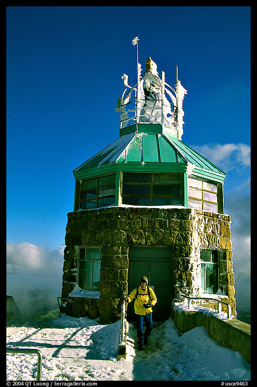 Hiker gets out of the ice-clad summit tower during a cold winter day, Mt Diablo State Park. SF Bay area, California, USA