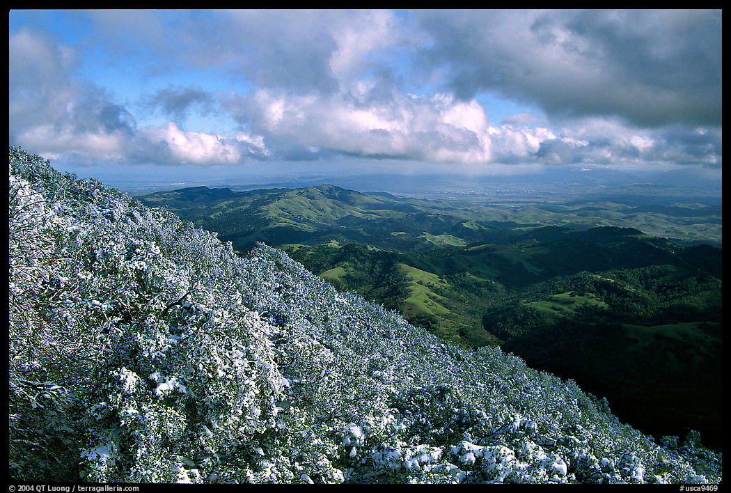 Looking towards green hills from the summit after a snow storm, Mt Diablo State Park. SF Bay area, California, USA