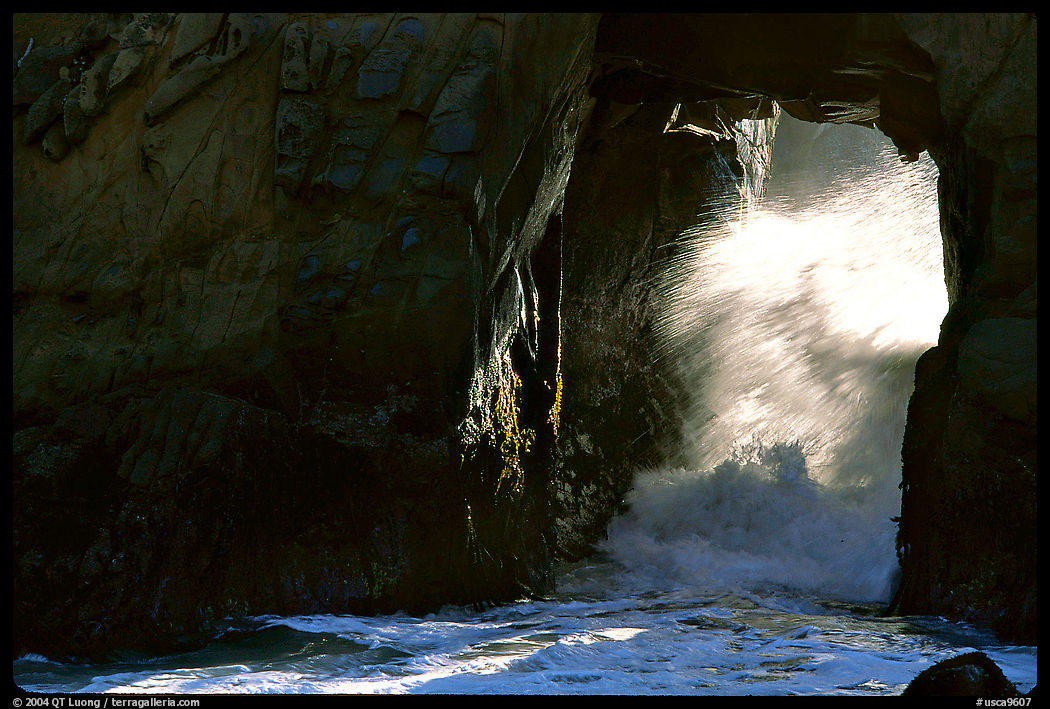 Light and wave through Arch Rock at Pfeiffer Beach. Big Sur, California, USA