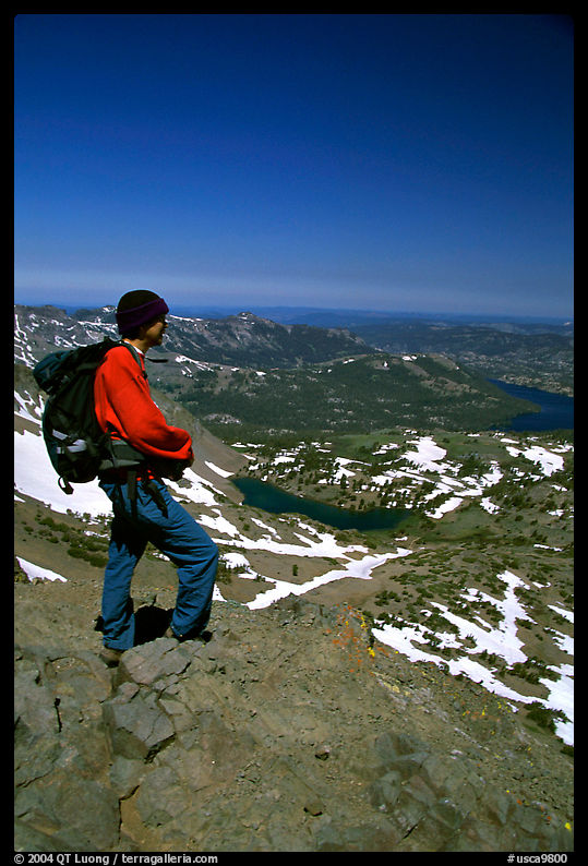 Hiker standing on top of Round Top Mountain. Mokelumne Wilderness, Eldorado National Forest, California, USA
