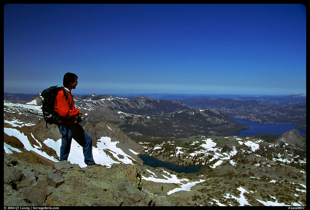 Hiker standing on top of Round Top Peak. Mokelumne Wilderness, Eldorado National Forest, California, USA