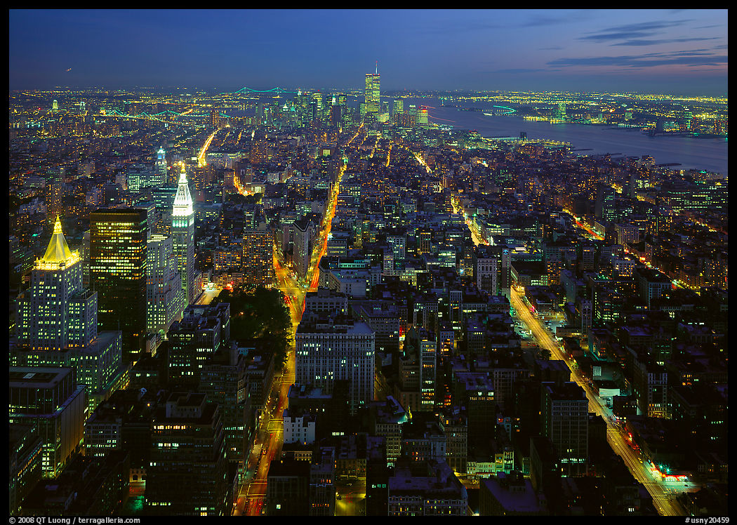 Streets at night from above with twin towers in background. New York City, USA