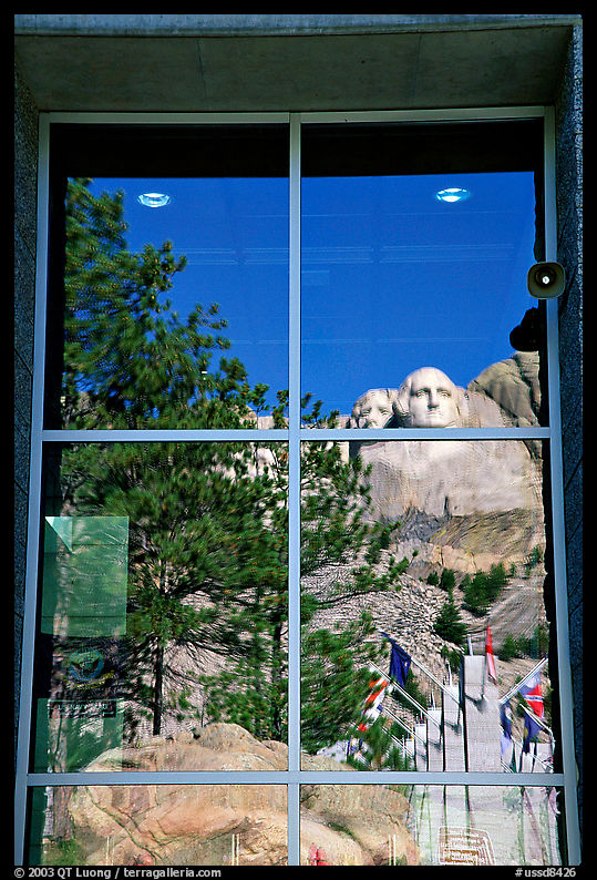Cliff and sculptures reflected in a window, Mount Rushmore National Memorial. South Dakota, USA