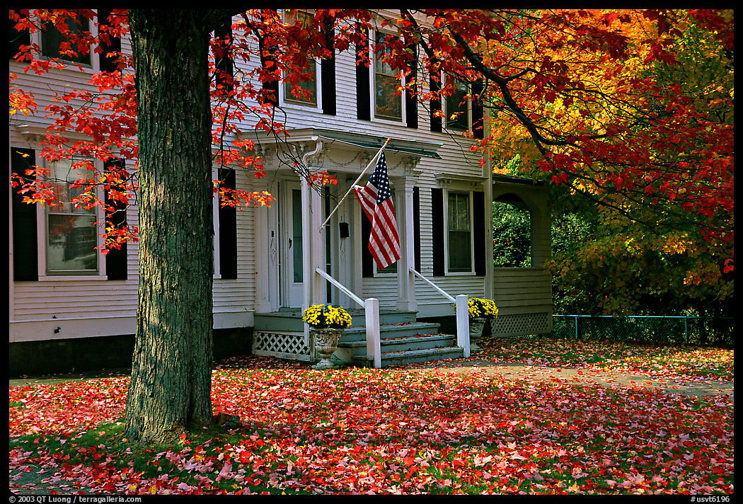 House with American flag and red leaves. Vermont, New England, USA