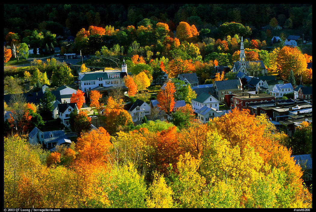 Village surounded by trees in brilliant fall colors. Vermont, New England, USA