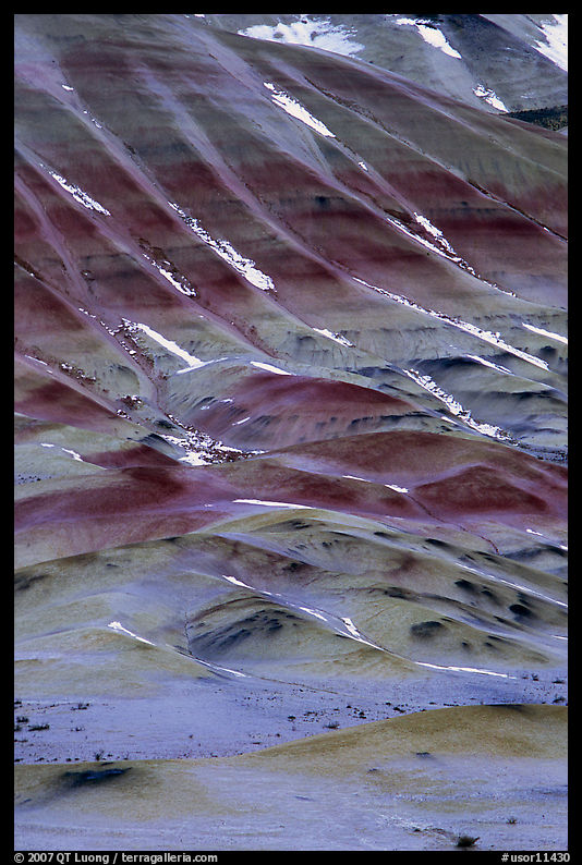 Colorful strata and snow on claystone hills. John Day Fossils Bed National Monument, Oregon, USA