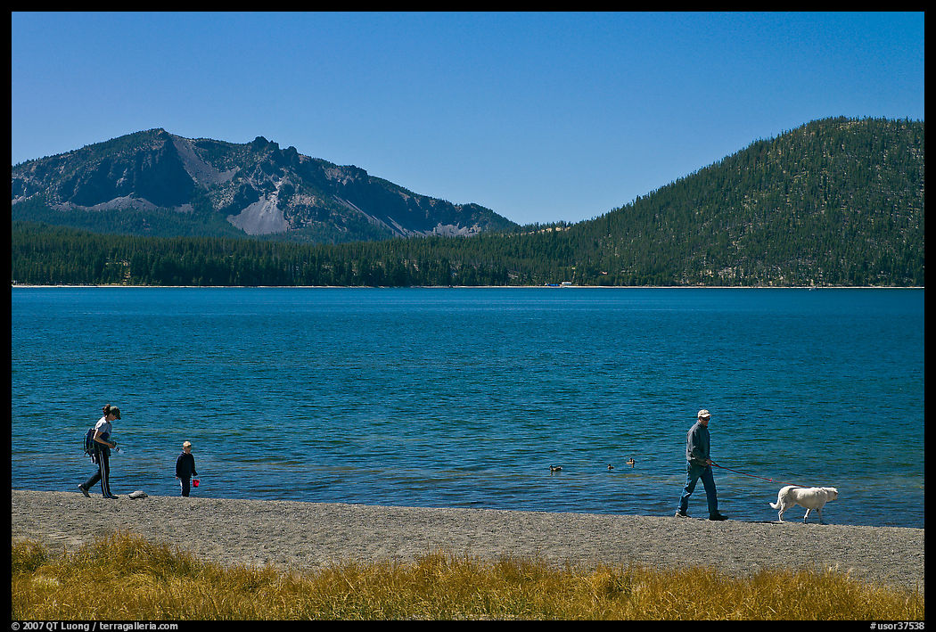 Family strolling on shore of East Lake. Newberry Volcanic National Monument, Oregon, USA