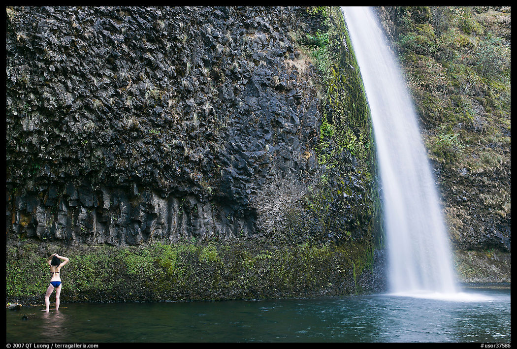 Woman in bikini at the base of Horsetail Falls. Columbia River Gorge, Oregon, USA