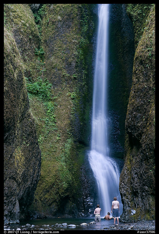 Men soaking at the base of Oneonta Falls. Columbia River Gorge, Oregon, USA