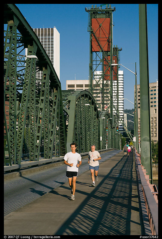 Men jogging on Hawthorne Bridge. Portland, Oregon, USA