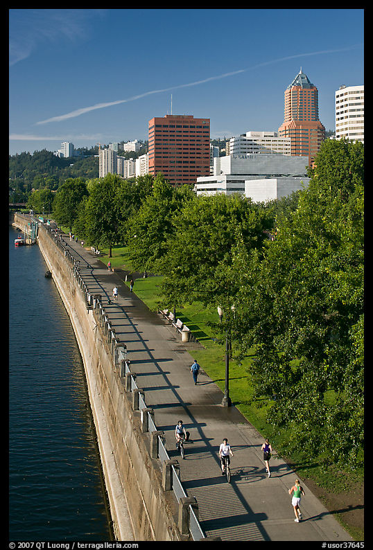People exercising at park on Williamette River waterfront, skyline. Portland, Oregon, USA