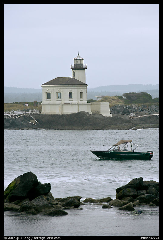 Small boat and Coquille River lighthouse. Bandon, Oregon, USA