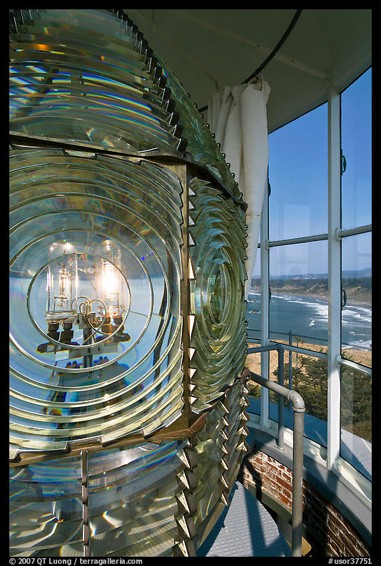 Rotating light inside Cape Bianco Lighthouse tower and landscape. Oregon, USA