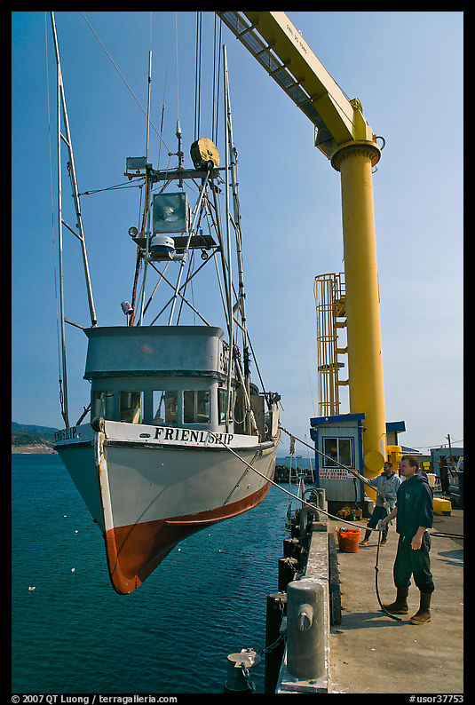 Fishing boat hoisted from water, Port Orford. Oregon, USA