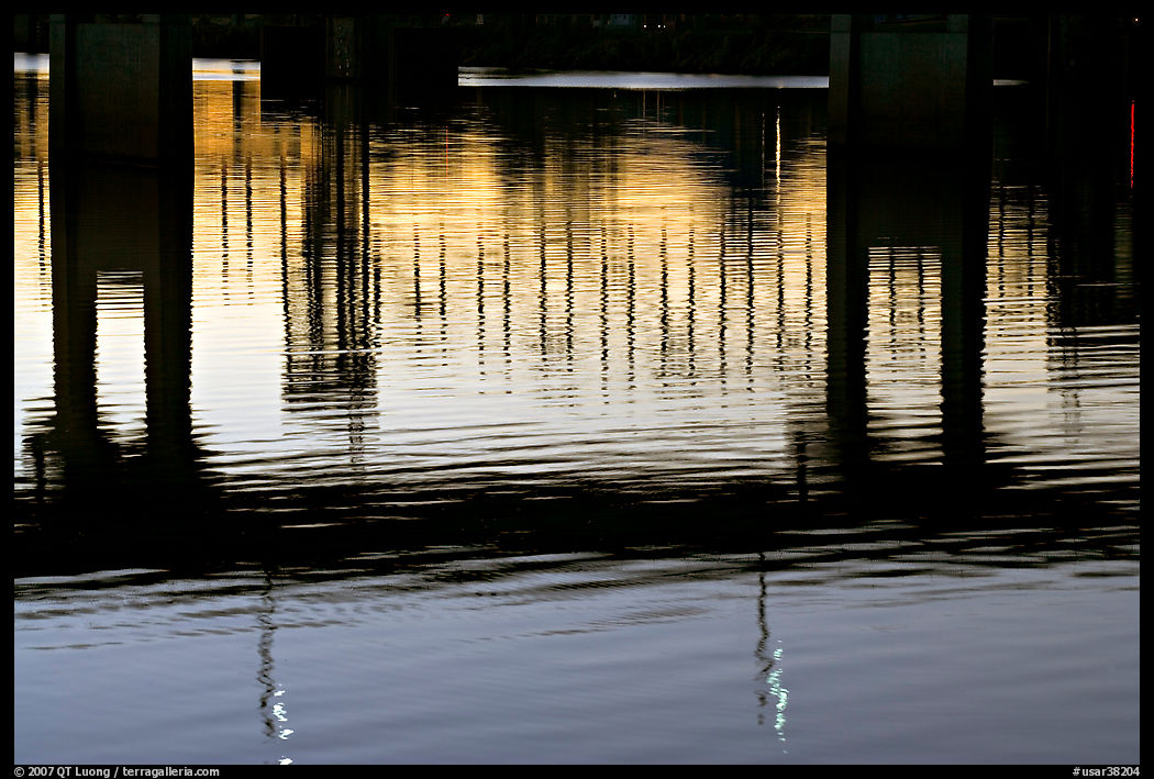 Bridges reflected in the Arkansas River at sunrise. Little Rock, Arkansas, USA