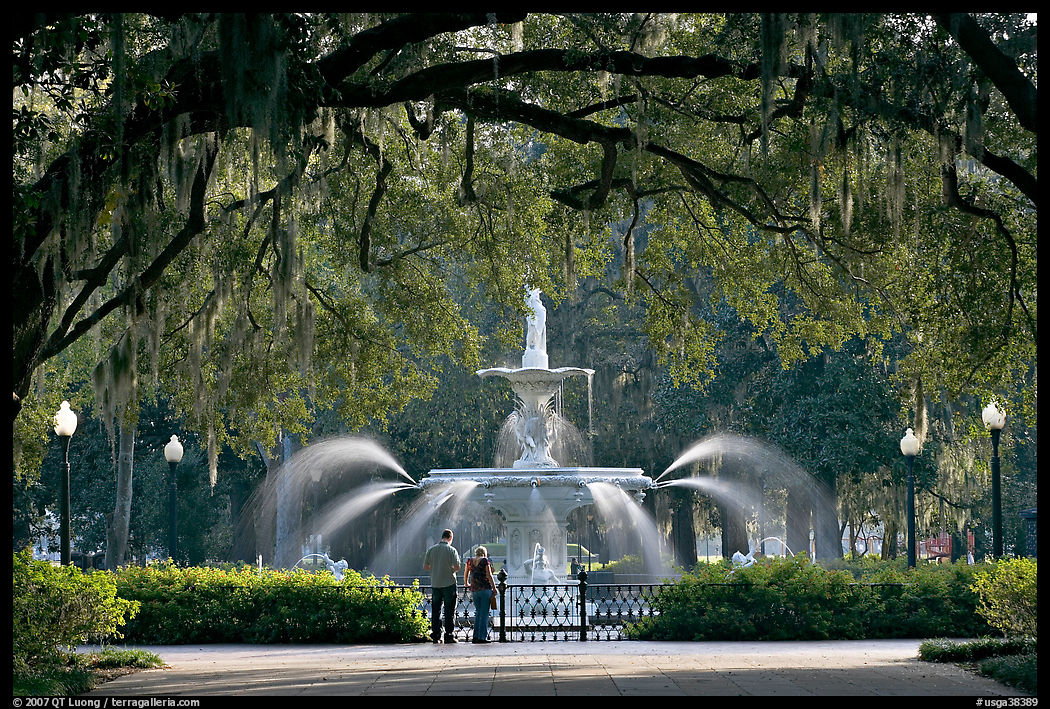 Fountain in Forsyth Park with couple standing. Savannah, Georgia, USA