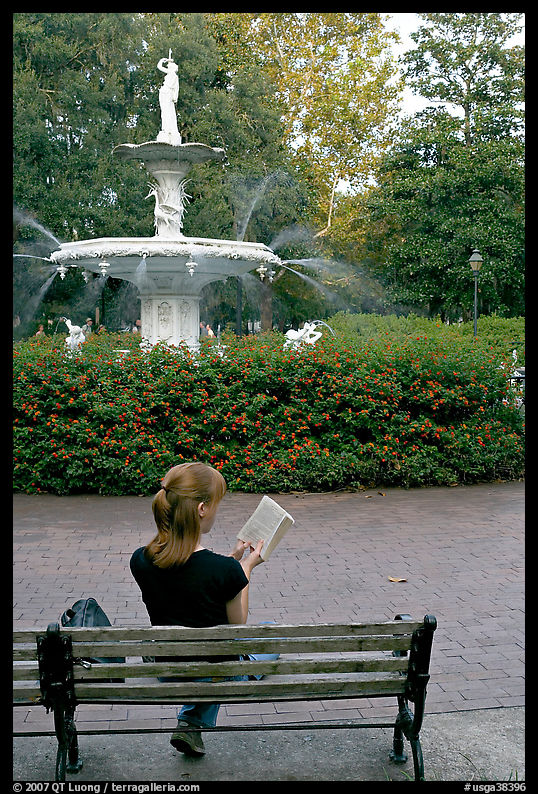 Woman reading a book in front of Forsyth Park Fountain. Savannah, Georgia, USA