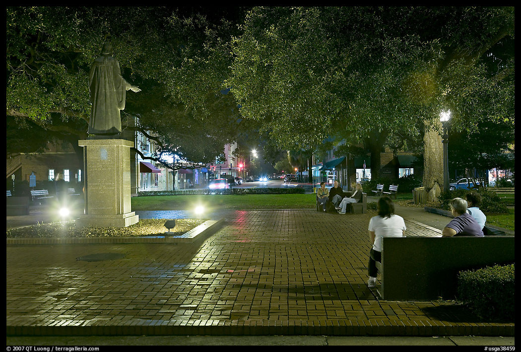 Square by night with people sitting on benches. Savannah, Georgia, USA