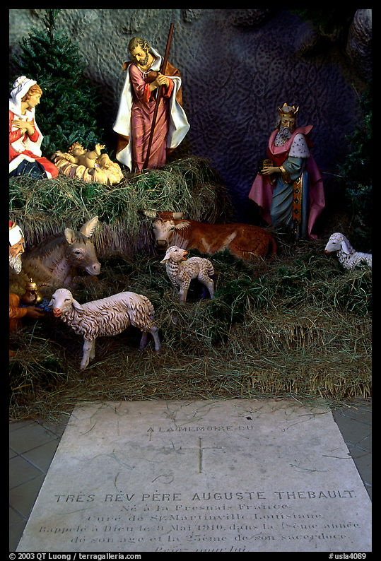 Tombstone of a French priest, and figures inside a replica of the Lourdes grotto, church Saint-Martin-de-Tours, Saint Martinville. Louisiana, USA