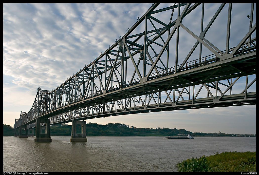 Barge on the Mississippi River approaching bridges. Natchez, Mississippi, USA