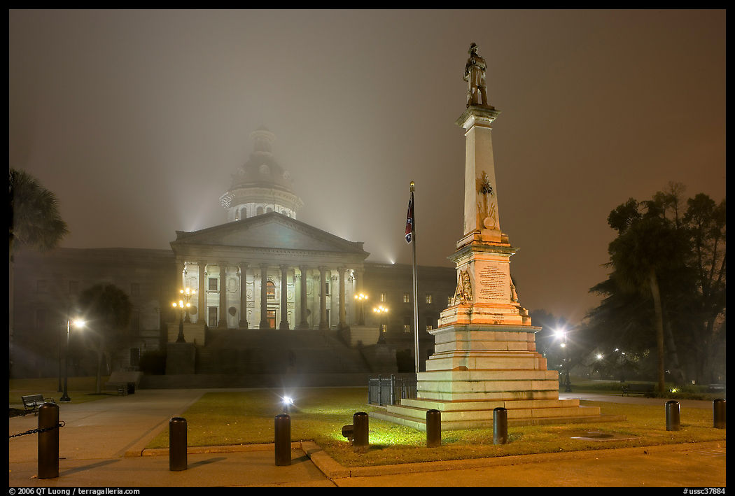 Monument to Confederate soldiers and state capitol at night. Columbia, South Carolina, USA