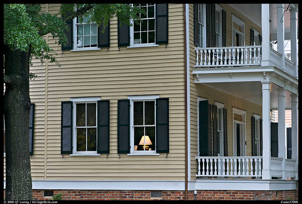 House with lamp inside window. Columbia, South Carolina, USA