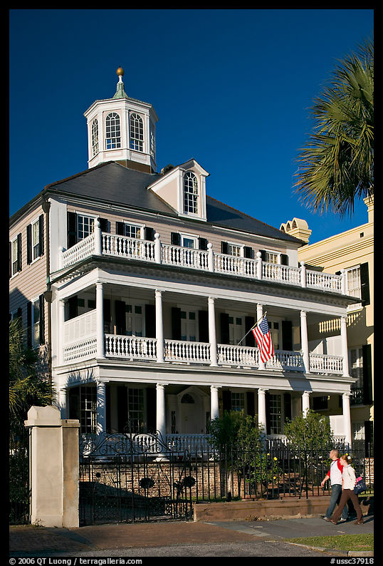 Couple walking in front of antebellum house. Charleston, South Carolina, USA