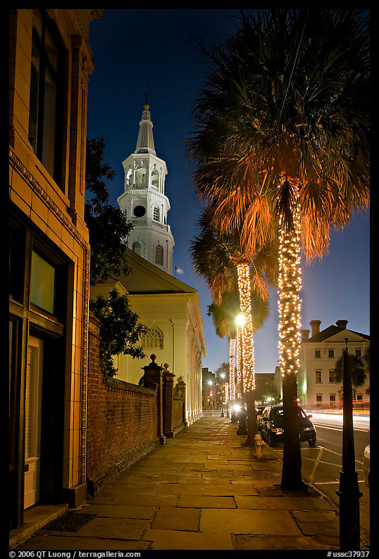 St Michael Episcopal Church, sidewalk, and palm trees at night. Charleston, South Carolina, USA
