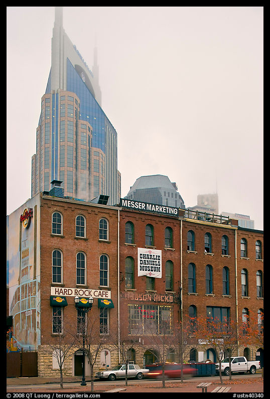 Row of brick buildings and Bell South Tower in fog. Nashville, Tennessee, USA
