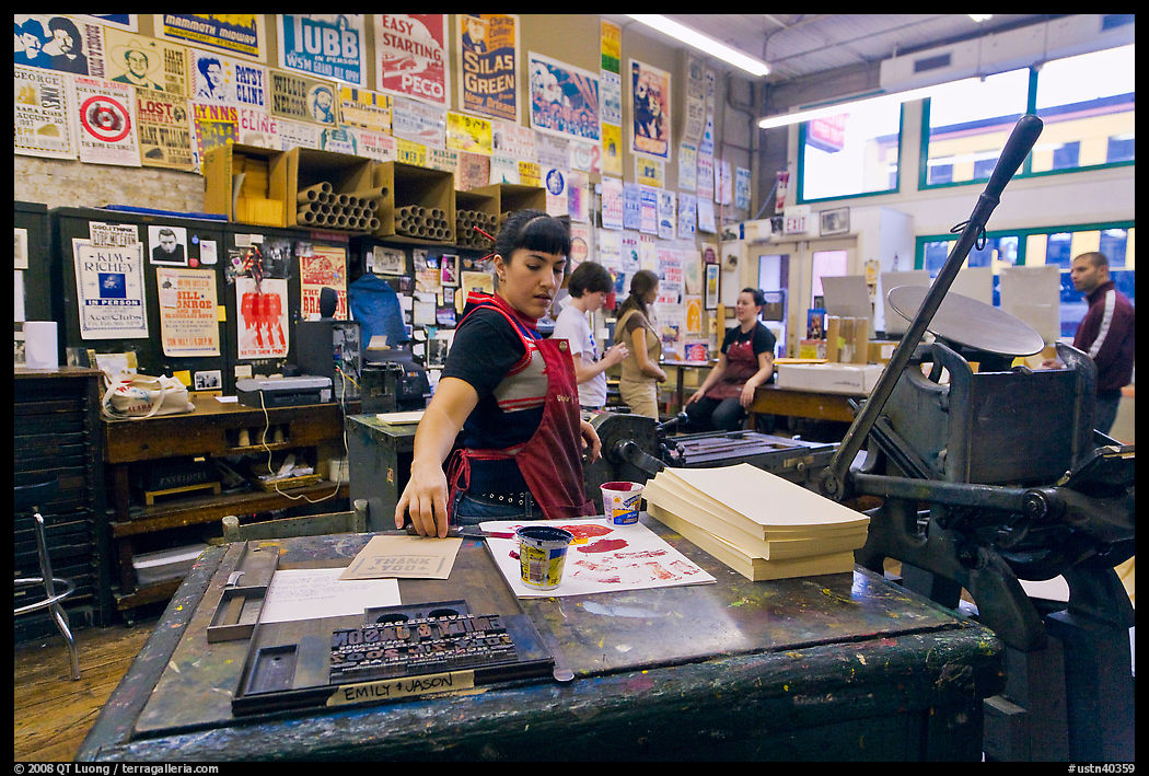Woman reaching for colored inks, Hatch Show print. Nashville, Tennessee, USA