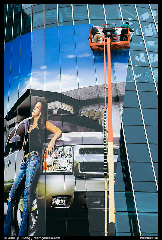 Workers pasting mural-sized car advertising on building. Nashville, Tennessee, USA