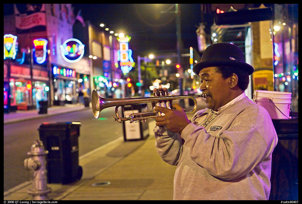 African-American man playing trumpet on Beale Street by night. Memphis, Tennessee, USA