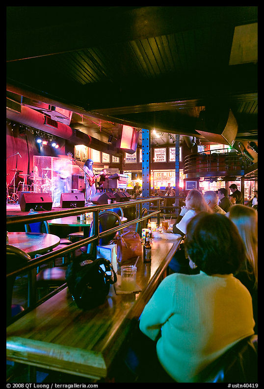 Patrons listen to musical performance in Beale Street bar. Memphis, Tennessee, USA