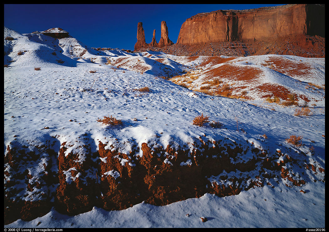 Snow on the floor, with Three Sisters in the background. Monument Valley Tribal Park, Navajo Nation, Arizona and Utah, USA
