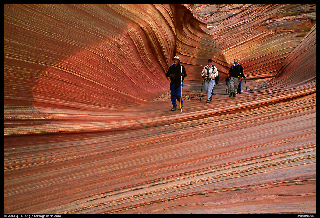 Hikers walk out of the Wave. Coyote Buttes, Vermilion cliffs National Monument, Arizona, USA