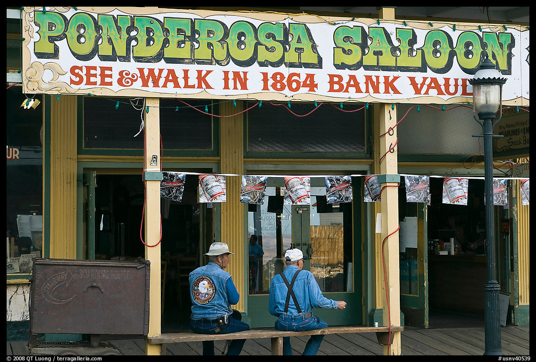 Men sitting on bench below Ponderosa Saloon sign. Virginia City, Nevada, USA