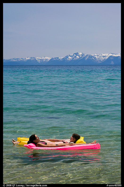 Girls laying on floating mattress, Sand Harbor, East Shore, Lake Tahoe, Nevada. USA